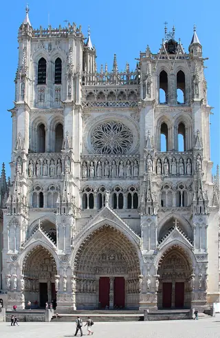 Three carved portals, a rose window and two towers fill the Gothic façade of Amiens Cathedral.