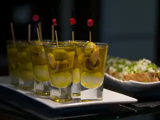 Pintxos in plain small glasses photographed in Vitoria-Gasteiz in 2016.