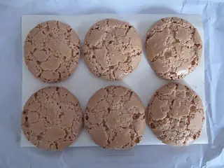 Regional food illustration of six Nancy-style macarons on paper; capture location unspecified.
