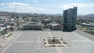 An elevated view across Sükhbaatar Square, its equestrian monument and surrounding city buildings.